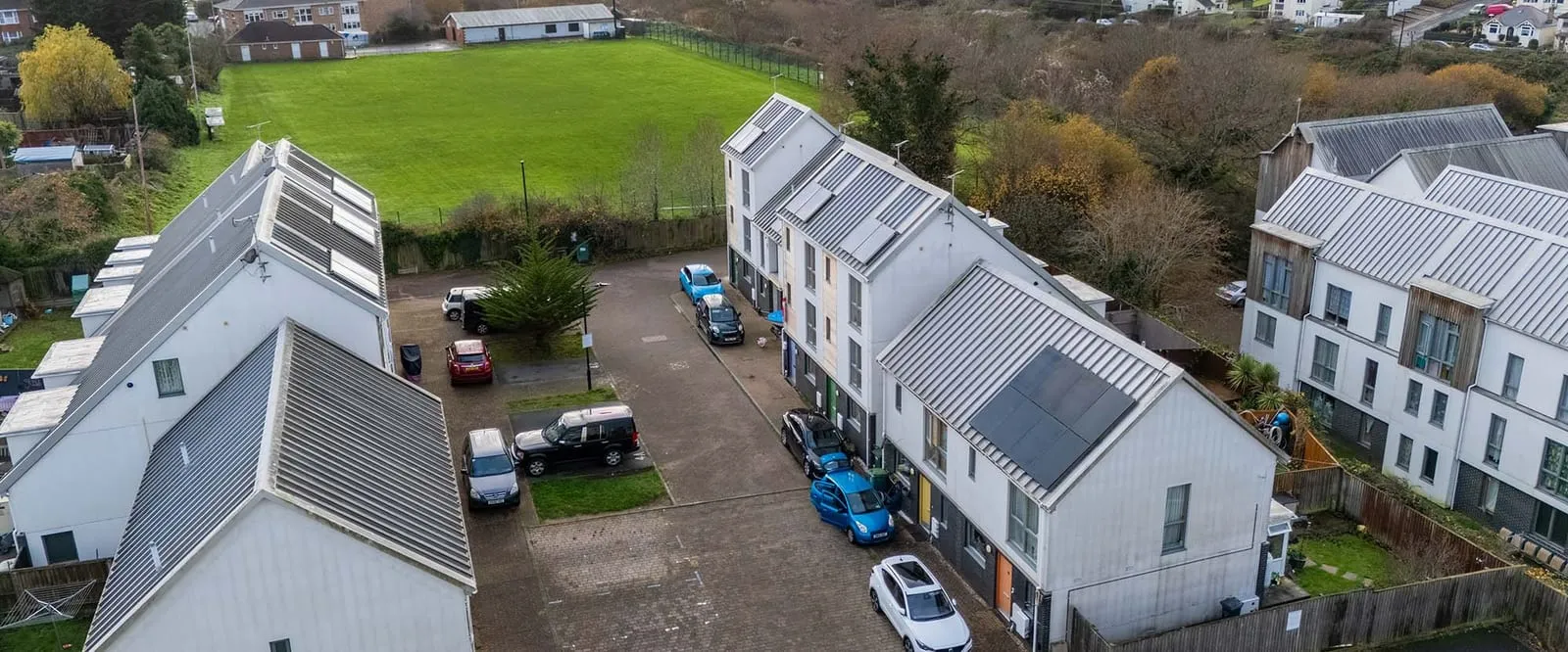 Aerial view of modern UK new-build homes with rooftop solar panels